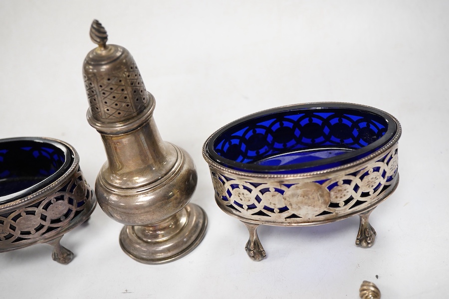 Sundry silver, consisting of - a pair of pepper pots, Birmingham, 1948 a pair of George III pierced oval salts, with blue glass liners and a modern silver candle snuffer with a turned wood handle.